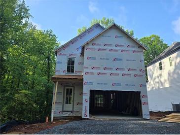 Two-story home's exterior is under construction with an attached two-car garage and wooded backdrop at 1664 Crestridge Se Dr, Marietta, GA 30067