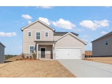 Charming two-story home with a two-car garage and a welcoming front porch at 4183 Viola Pl, Atlanta, GA 30349