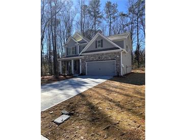 Charming two-story home featuring stone accents, a gray color scheme, and an attached two-car garage at 2280 Highridge Point Dr, Lithia Springs, GA 30122