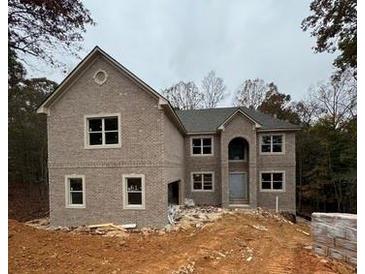 Two-story brick home with attached garage and landscaping at 4251 Matisse Ln, Fairburn, GA 30213