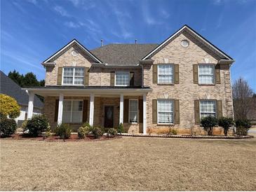 Charming brick home with a covered front porch and landscaped front yard at 1251 Marlton Chase Dr, Lawrenceville, GA 30044