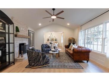 Spacious living room features a fireplace and large windows at 13130 Providence Rd, Milton, GA 30009