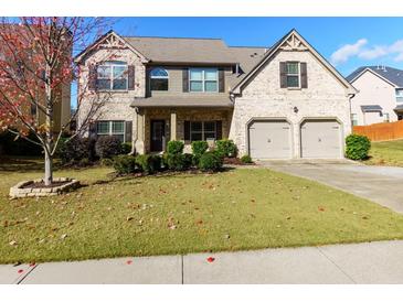 Two-story brick home with a two-car garage and manicured lawn at 108 Laurel Bay Se Dr, Loganville, GA 30052