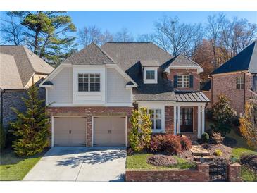 Brick two-story house with two-car garage and landscaped yard at 3909 Collarton Close Se, Smyrna, GA 30080