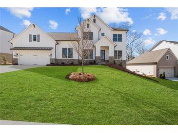 Two story home with white siding, stone accents, and a grassy lawn at 2023 Fern Mountain Ln, Marietta, GA 30064