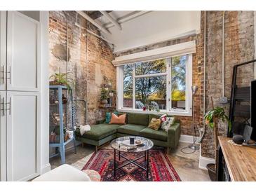 Spacious living area with exposed brick, large window, and comfortable seating at 978 North Ne Ave # 107, Atlanta, GA 30306