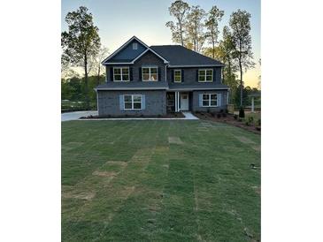 Charming two-story home with manicured front yard and landscape at 3030 Fairway Dr, Villa Rica, GA 30180