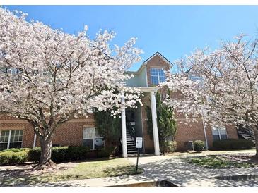 Brick condo building adorned with blossoming trees on a sunny day at 245 Amal Sw Dr # 1008, Atlanta, GA 30315