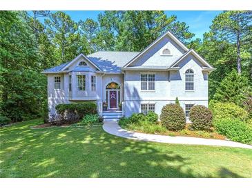 Charming traditional home featuring a manicured lawn and a light gray exterior at 27 Danbury Hill # Coweta, Sharpsburg, GA 30277