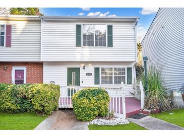 Charming two-story home with landscaped yard and white siding at 6323 Wedgeview Dr, Tucker, GA 30084