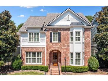 Brick two-story house with white accents and landscaping at 255 Kendemere Pointe, Roswell, GA 30075