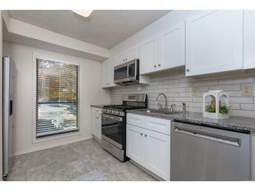 Bright kitchen featuring stainless steel appliances and granite countertops at 811 Wynnes Ridge Se Cir, Marietta, GA 30067