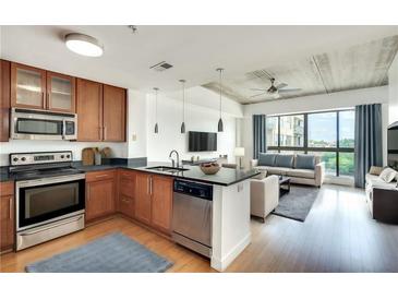 Modern condo with open floor plan featuring wood floors, a modern kitchen, and a spacious living area with plenty of natural light at 563 Memorial Se Dr # 503, Atlanta, GA 30312