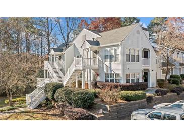 Well maintained condo complex with multiple units, staircases, and manicured landscaping at 1115 Cannongate Sw Xing, Marietta, GA 30064