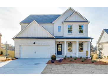 Two-story white brick home with gray roof and landscaping at 2870 S Waterworks Rd, Buford, GA 30518