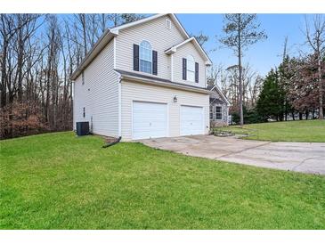 Two-story house with a two-car garage and grassy yard at 254 Cobblestone Ln, Mcdonough, GA 30252