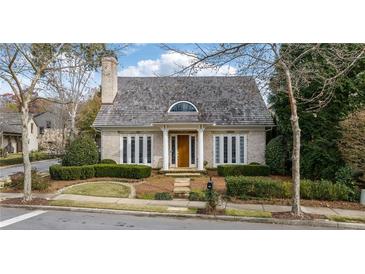 Charming brick home with a shingled roof and manicured landscaping at 6830 Vickery Creek Rd, Cumming, GA 30040