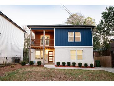 Two-story home with blue and white siding, balcony, and landscaped yard at 1330 Lockwood Sw Dr, Atlanta, GA 30311
