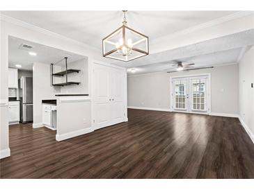 Bright living room with hardwood floors and access to a patio at 6900 Roswell Rd # 20Q, Sandy Springs, GA 30328