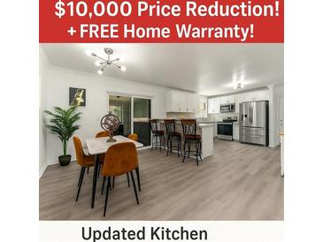 Spacious updated kitchen with stainless steel appliances, breakfast bar, and adjoining dining area at 2793 Heritage Ln, Morrow, GA 30260