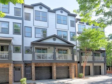 Inviting townhome with a charming covered balcony and attached garages for convenient parking at 221 Semel Nw Cir # 273, Atlanta, GA 30309