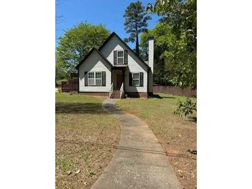 Charming home with a gabled roof, black shutters, and a walkway leading to the front door at 333 Pickfair Sw Way, Atlanta, GA 30315