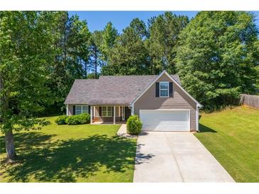 Charming single-Gathering home with a well-manicured lawn and attached two car garage in a wooded neighborhood at 90 Loudoun Dr, Covington, GA 30014