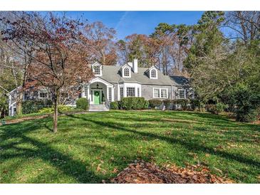 Gray shingled home with green door, large yard, and mature trees at 1225 W Wesley Nw Rd, Atlanta, GA 30327