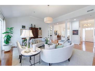 Bright living room featuring hardwood floors, curved sofas, and an open floor plan at 3101 Howell Mill Nw Rd # 327, Atlanta, GA 30327