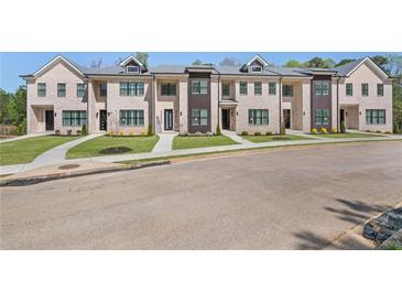 Charming townhomes with manicured lawns and elegant brick facades provide curb appeal at 161 Brush Creek Ct, Stockbridge, GA 30281