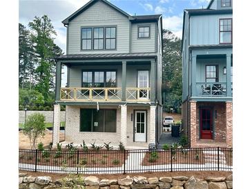 Charming two-story home with a welcoming front porch and black metal fence at 1995 Catnap Ct, Chamblee, GA 30341