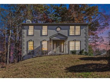 Two-story home with a covered entrance and professionally landscaped front yard at 508 Sutters Mill Rd, Stone Mountain, GA 30087