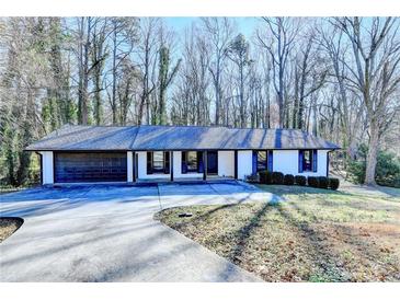 Ranch style home with attached two-car garage and landscaped yard at 1900 Mornington Ln, Snellville, GA 30078