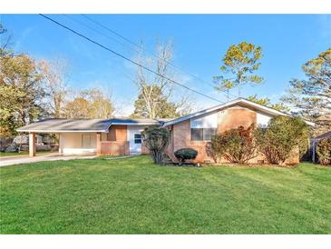 Brick ranch house with carport and well-maintained lawn at 3762 Elkridge Dr, Decatur, GA 30032