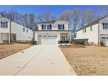 Two-story house with white siding, a gray stone base, and a two-car garage at 4745 Marjorie Dr, Cumming, GA 30041