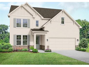 Two-story home with beige siding, stone accents, and a two-car garage at 63 Rocking Wood Vw, Dallas, GA 30157