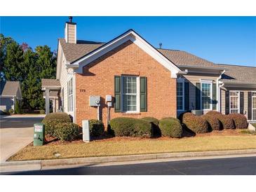 Charming brick home featuring manicured landscaping, a new roof, and beautiful architectural details at 778 Camry Cir, Dallas, GA 30157