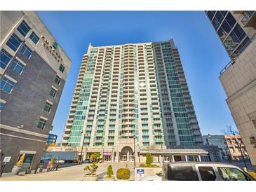 High-rise condo with green glass exterior, multiple balconies, and street-level parking at 361 17Th Nw St # 2208, Atlanta, GA 30363