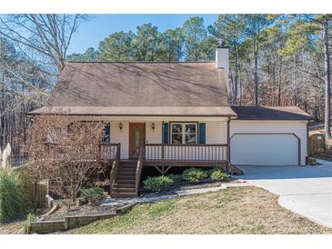 Ranch style home with attached garage, deck, and landscaped yard at 4706 Warrior Se Way, Mableton, GA 30126