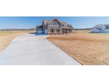 Charming craftsman home features a spacious front yard and a long, curving driveway at 1422 Alcovy Station Rd, Covington, GA 30014