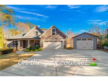 House exterior showing a two-story home with a three-car garage and landscaped yard at 7042 Confederate Ct, Villa Rica, GA 30116