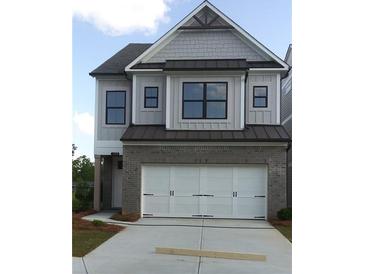 Beautiful home with a brick and siding facade, a three-car garage, and modern black trimmed windows at 1059 Crest Mill Dr, Marietta, GA 30008