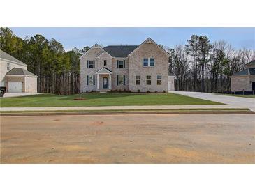 Two-story brick home with gray shutters and a landscaped lawn at 301 Delta Dr, Mcdonough, GA 30252