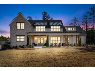 Two-story farmhouse with metal roof, large porch, and landscaping at 39 Telfair Ct, Acworth, GA 30101