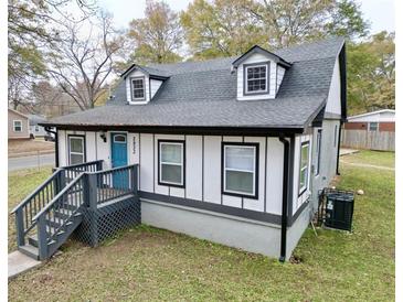 Charming craftsman style home with gray exterior, blue door and landscaping at 2933 5Th Sw St, Atlanta, GA 30315