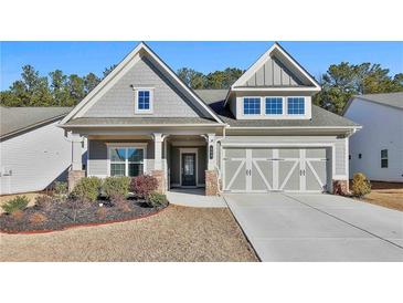 Gray house with stone accents and a 2-car garage at 590 Plainfield St, Fayetteville, GA 30215