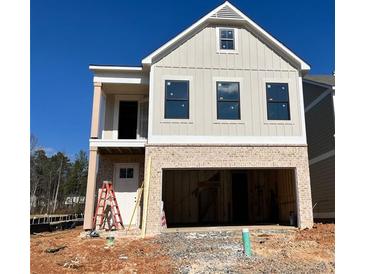 Two-story house with beige siding, brick bottom, and a two-car garage at 1074 Crest Mill Dr, Marietta, GA 30008