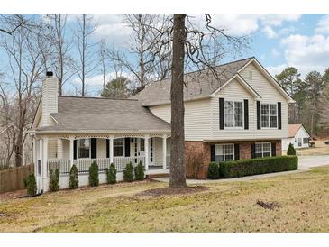 Charming two-story home featuring a welcoming front porch, complemented by black shutters and well-maintained landscaping at 2965 Ivy Mill Dr, Buford, GA 30519