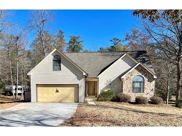 Charming single-Gathering home featuring stone accents, a two-car garage, and a well-manicured front lawn at 75 Briar Patch Rd, Covington, GA 30014