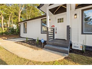 Charming front porch with stylish gray steps, white siding, and freshly landscaped yard at 358 Roy Sw St, Atlanta, GA 30310